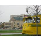 Kenosha: Electric Trolley on its rail, the background is the Chops on the Lake, along with the Lakeside Tower Apartments