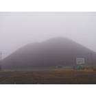 McAdoo: Fog blurs the view of a huge coal mountain on the side of the road.