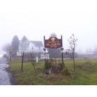 Welcome sign to McAdoo, Pennsylvania on a rainy, foggy day.