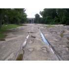Round Rock: Wagon Tracks along the Chisholm Trail next to Brushy Creek. Whenever it rains these rocks are under water.