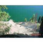Thompson Falls: Blueside Road is a curving residential and country road that follows the brilliant Clark Fork River. This photo depicts the brilliant contrast of white sandy cliff and brilliant blue of the Clark Fork River.