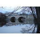 Henniker: Early evening shot of Twin Stone Arch Bridge over Contoocook River in Henniker, N.H., from campus of New England College