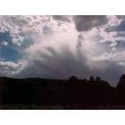 Ramah: Clouds in the shape of a hand over cliffs by Ramah Lake