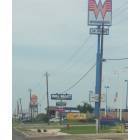 Pleasanton: The signs of businesses along Hwy. 97 in Pleasanton, Texas