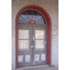 Calvert: Store front window with red brick arch