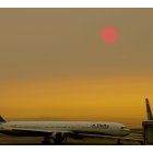 San Francisco: : SMOKE FROM NEARBY FIRES turns the morning sun red over San Francisco International Airport in September 2007.
