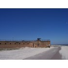 Dauphin Island: A cannon on Fort Gaines guards the mouth of Mobile Bay. Note the seagull on the right edge of the image. Bienville Boulevard curves around the base of the fort.