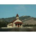 Cambria: Old San Simeon Schoolhouse watched over by Hearst Castle