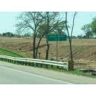 Cross Roads: : City Limit sign on US 380 - Site of new Wal-Mart in background