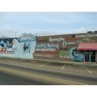 Mendenhall: Local artist painting on hardware store side