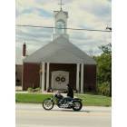 Hillsboro: Motorcylist waving in front of church along Highway 21.