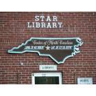 Star: Old town hall, now library. With sign showing Star as the geographical center of NC