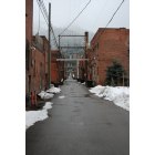 Wallace: an alley of brick buildings in early spring in Wallace
