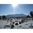Truth or Consequences: : City cemetery with sun rising over Turtleback Mountain in background