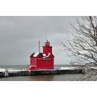 Holland: : Big Red in the winter with snow on areas of the lighthouse.